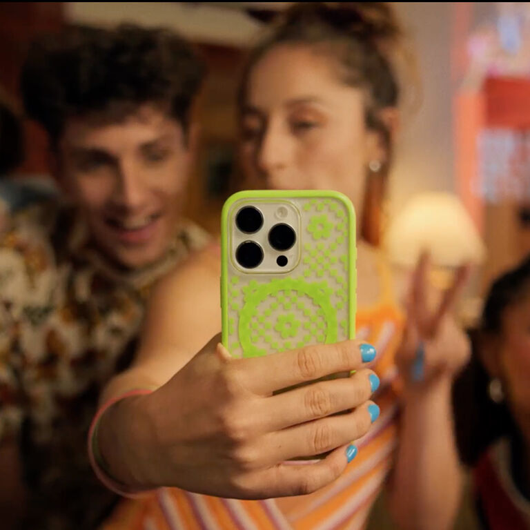 woman holding a bright green iphone case | OtterBox